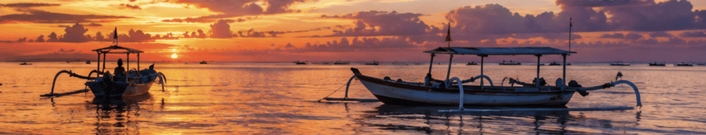 Traditional Balinese outrigger fishing boats resting on the water at sunset