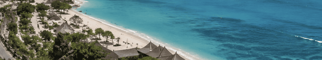 Aerial view of a curved beach with thatched umbrellas along Bali's coast
